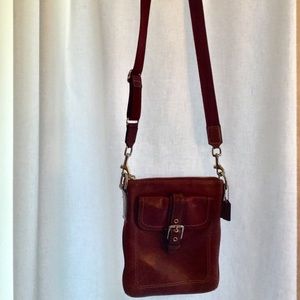 Rich, thick Coach burgundy leather crossbody bag.